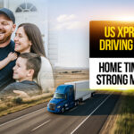 Smiling truck driver hugging his family outside their home, with a semi-truck on the highway in the background, representing US Xpress driving jobs focused on work-life balance.