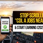 Truck driver inside a semi truck holding a phone with a job match found screen, promoting CDL A jobs near me and earning opportunities in 2026.